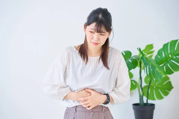 Young Woman Suffering Abdominal Pain Indoors — Stock Photo, Image