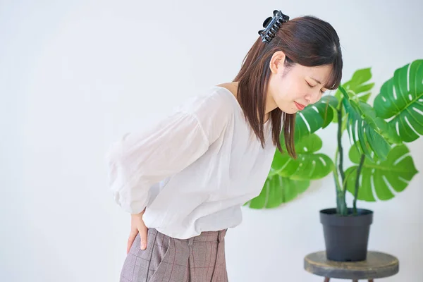 Young Woman Suffering Back Pain Indoors — Stock Photo, Image