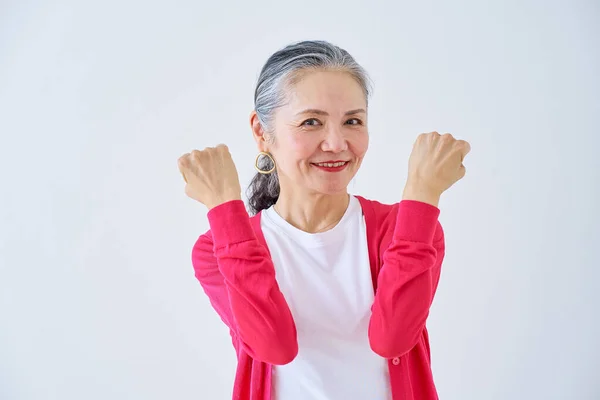 Senior Woman Fist Pumping Indoors — Stock Photo, Image