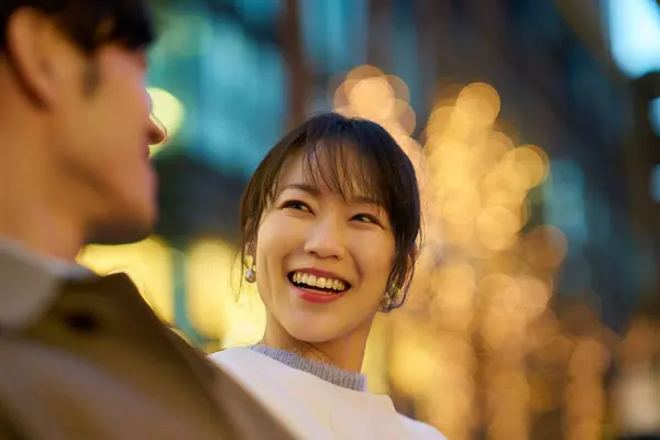 Женщина Счастливо Разговаривает Мужчиной Освещенном Городском Пейзаже — стоковое фото