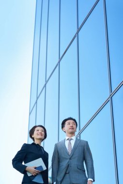 Güzel bir günde takım elbiseli kadın ve erkek modern mimari