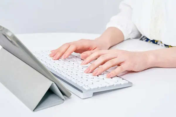 stock image Hands of a woman typing on a keyboard