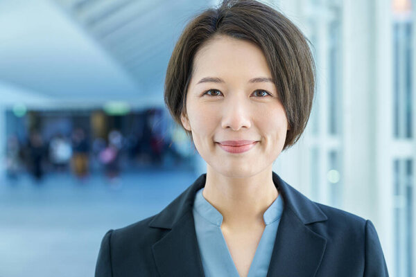 Portrait of a smiling business woman in the aisle
