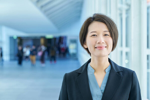 Portrait of a smiling business woman in the aisle