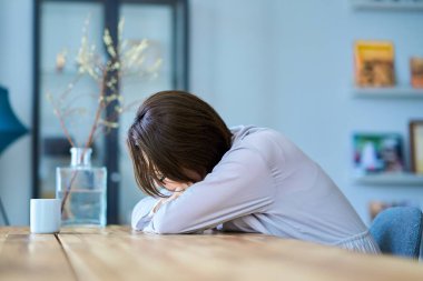 Orta yaşlı bir kadın odasında mola veriyor.