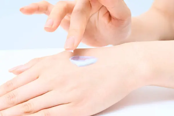 stock image Hands of a woman doing hand care and white background