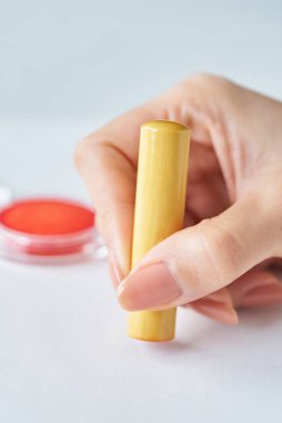 close up of hands stamping a white piece of paper clipart