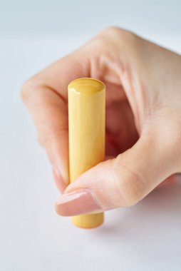 close up of hands stamping a white piece of paper clipart