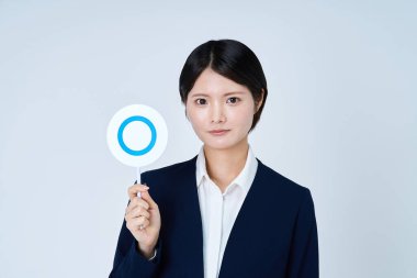 A woman in a suit holding a plate with a circle on it and white background clipart