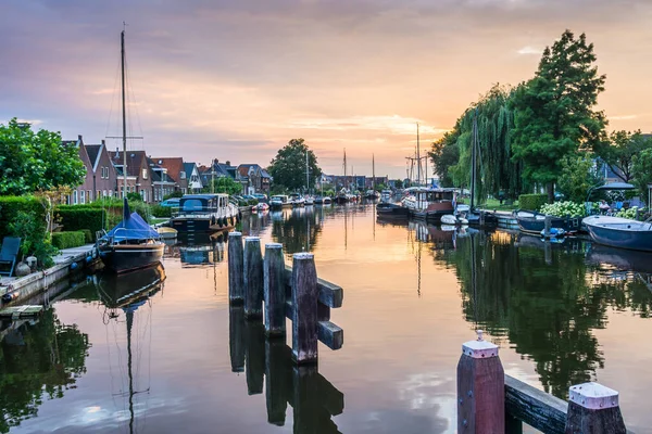 stock image Lemmer, Netherlands - August 15, 2022: View of a water canal in the city of Lemmer in Friesland, Netherlands in beautiful sunset light