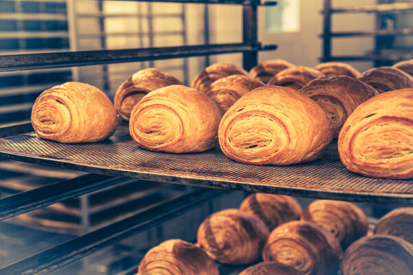 A female baker weighs pieces of dough. Traditional craft. Vintage style with grain.