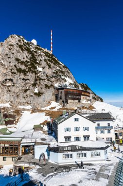 Wendelstein, Bavaria, Germany, 14.04.2024: View of the buildings on Wendelstein mountain in Germany on a sunny winter day. Vertical with copy space.  clipart