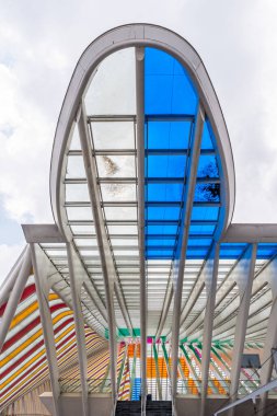 Liege, Belgium - 20.05.2024: Guillemins station with stained glass windows. Station was designed by architect Santiago Calatrava and opened in 2009. Vertical. clipart