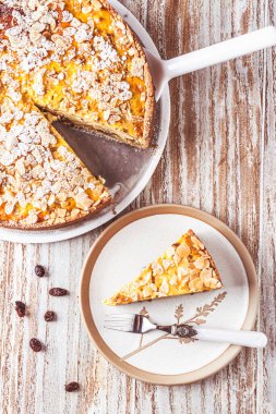 Beyaz ahşap arka planda kavrulmuş bademli ev yapımı elmalı turta.