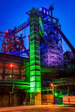 Illuminated part of the ruin of steelmill in the Landschaftspark Duisburg-Nord, vertical clipart