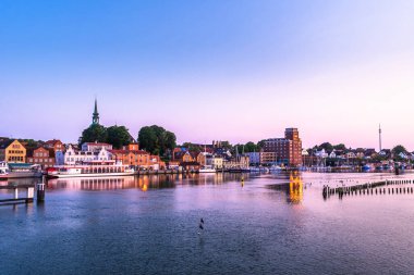 Kuzey Almanya 'daki Kappeln manzarası, Schlei nehrinin kıyısında güzel bir yaz gündoğumu güneşi altında küçük bir kasaba.