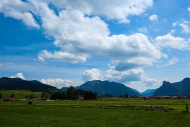 Unterammergau in Bavaria, with fields and mountains in the background clipart
