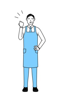 Önlüklü kıdemli bir adam cesaretle poz veriyor..