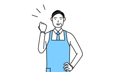 Önlüklü kıdemli bir adam cesaretle poz veriyor..