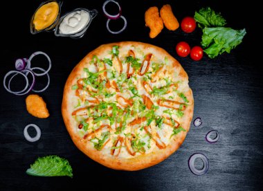 Pizza with nuggets and cheese. Close up