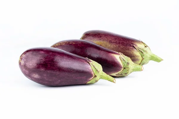 stock image Three ripe eggplants on a white background. Summer seasonal products concept.