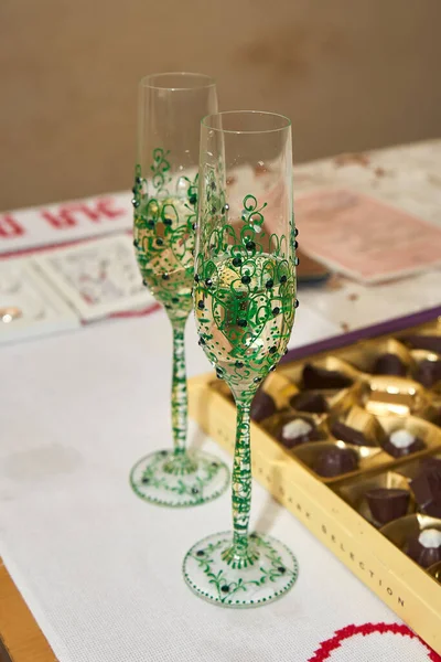 Vertical shot of champagne glasses standing on a table during a wedding celebration