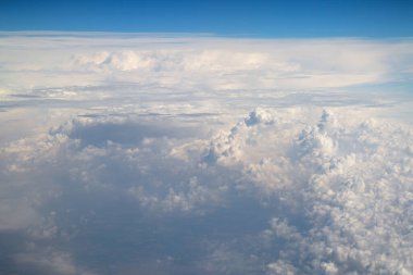 view above clouds from airplane window, above the clouds