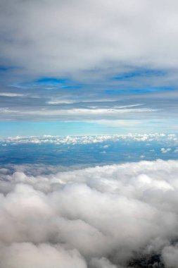 view above clouds from airplane window, above the clouds