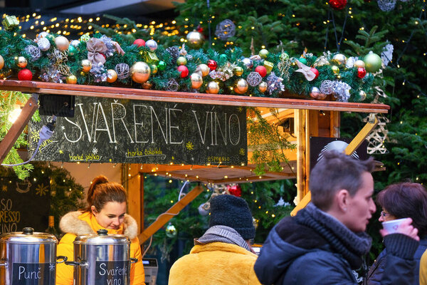 people are shopping and enjoying the Christmas atmosphere at the Christmas market, Christmas market in Prague, sales of mulled wine and punch at the Christmas market