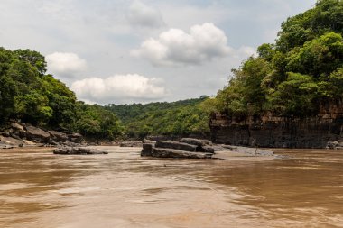 Kayalar, Amazon nehri, tekneler ve orman Kolombiya Amazon bölgesinde, bulutlu ve yeşil resim