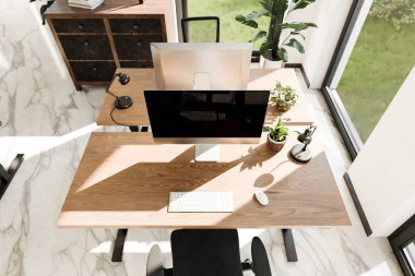 top down perspective of minimalistic pc workspace in luxurious loft office and panoramic view; remote work home office concept; bright daylight; 3D rendering
