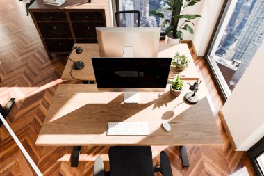 top down perspective of minimalistic pc workspace in luxurious loft office and panoramic view; remote work home office concept; bright daylight; 3D rendering