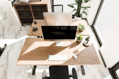 top down perspective of minimalistic pc workspace in luxurious loft office and panoramic view; remote work home office concept; bright daylight; 3D rendering