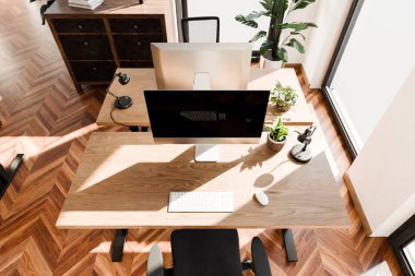 top down perspective of minimalistic pc workspace in luxurious loft office and panoramic view; remote work home office concept; bright daylight; 3D rendering