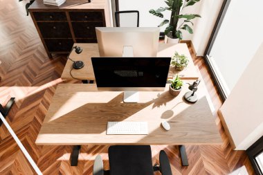 top down perspective of minimalistic pc workspace in luxurious loft office and panoramic view; remote work home office concept; bright daylight; 3D rendering