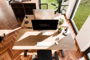 top down perspective of minimalistic pc workspace in luxurious loft office and panoramic view; remote work home office concept; bright daylight; 3D rendering