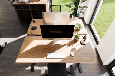 top down perspective of minimalistic pc workspace in luxurious loft office and panoramic view; remote work home office concept; bright daylight; 3D rendering