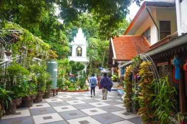 Tourists walking atThe gold Temple ground in Wat Prathat Doi Suthep, Thailand clipart