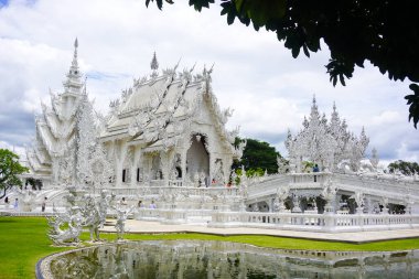 Entrance view at the white Temple in WatRong Khun, Thailand clipart