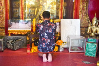 Buddhist worshipping at the gold Temple in Wat Prathat Doi Suthep, Thailand clipart