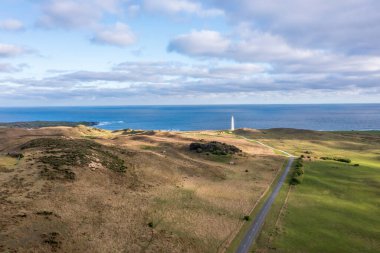 Drone aerial photograph of Cape Wickham Lighthouse early in the morning on a cloudy day in Currie on the northern part of King Island in Tasmania
