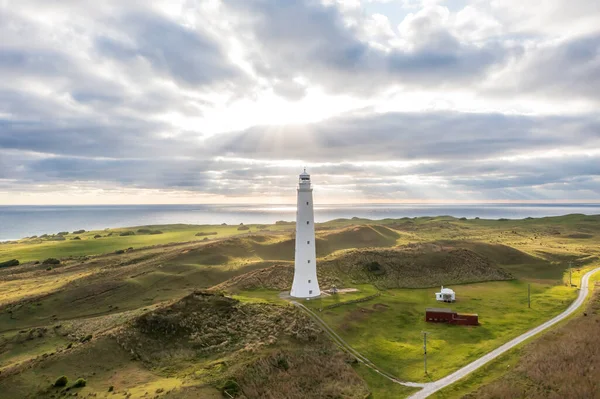 Drone aerial photograph of Cape Wickham Lighthouse early in the morning on a cloudy day in Currie on the northern part of King Island in Tasmania