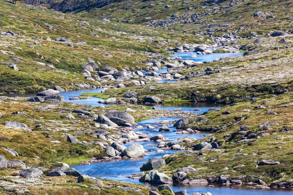 stock image Photograph of a fresh water river flowing through a green rocky valley in the Snowy Mountains in New South Wales in Australia