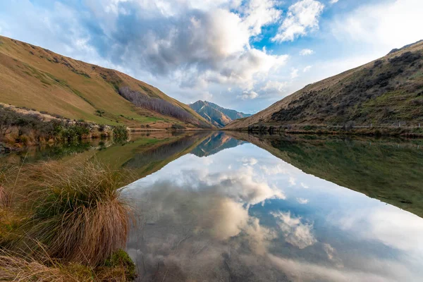 stock image Photograph of Lake Kirkpatrick with mountains reflecting in the water on a cloudy day outside Queenstown on the South Island of New Zealand