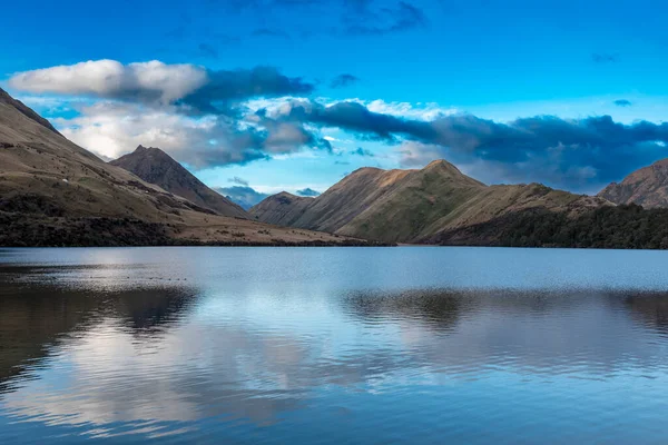 stock image Photograph of Lake Moke with mountains reflecting in the water on a cloudy day outside Queenstown on the South Island of New Zealand