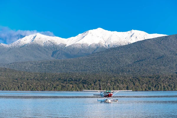 stock image Photograph of a Sea Plane on Te Anau Lake in front of snow capped mountains in the township of Te Anau in Fiordland on the South Island of New Zealand