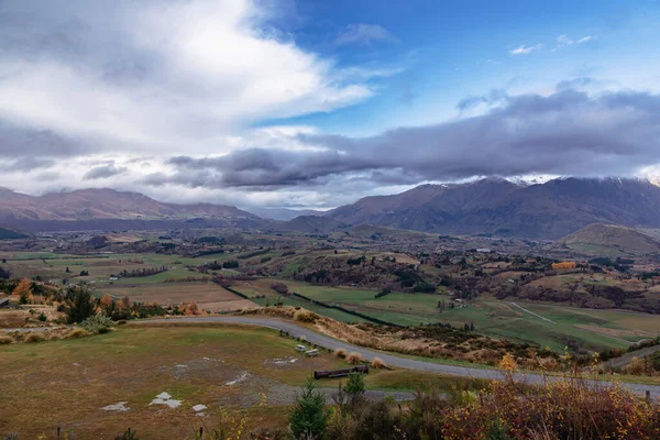 stock image Photograph from Coronet Peak of a mountain range and a large agricultural valley on a cloudy day in Queenstown on the South Island of New Zealand