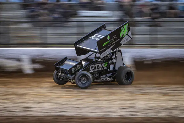 stock image SYDNEY, NEW SOUTH WALES, AUSTRALIA - March 23, 2024 : Driver Ryan Newton racing in the SprintCar Dirt Track Racing Series at Sydney International Speedway.