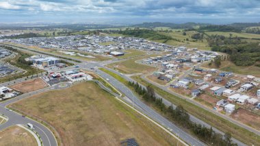 Drone aerial photograph of construction and infrastructure development in the fast growing suburb of Oran Park in the high density development region of western Sydney, NSW Australia. clipart