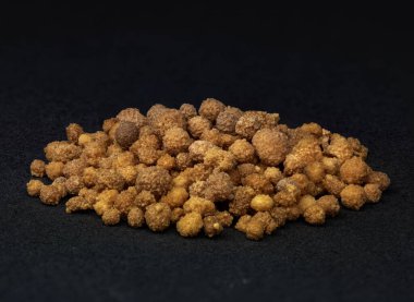 granules - group of brown granules macro shot, black background